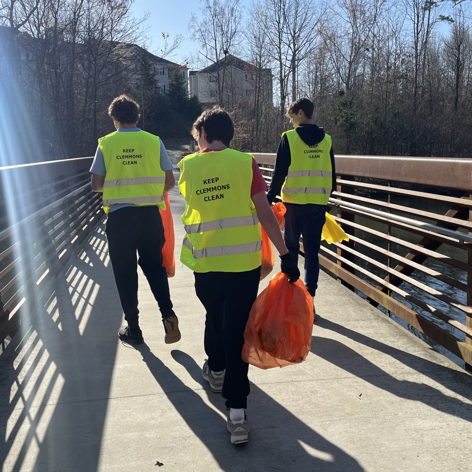 image-20250322-133550-67b7d2fe (1) Three youth in safety vests with trash bags